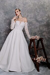 girl pose with off shoulder white eden gown