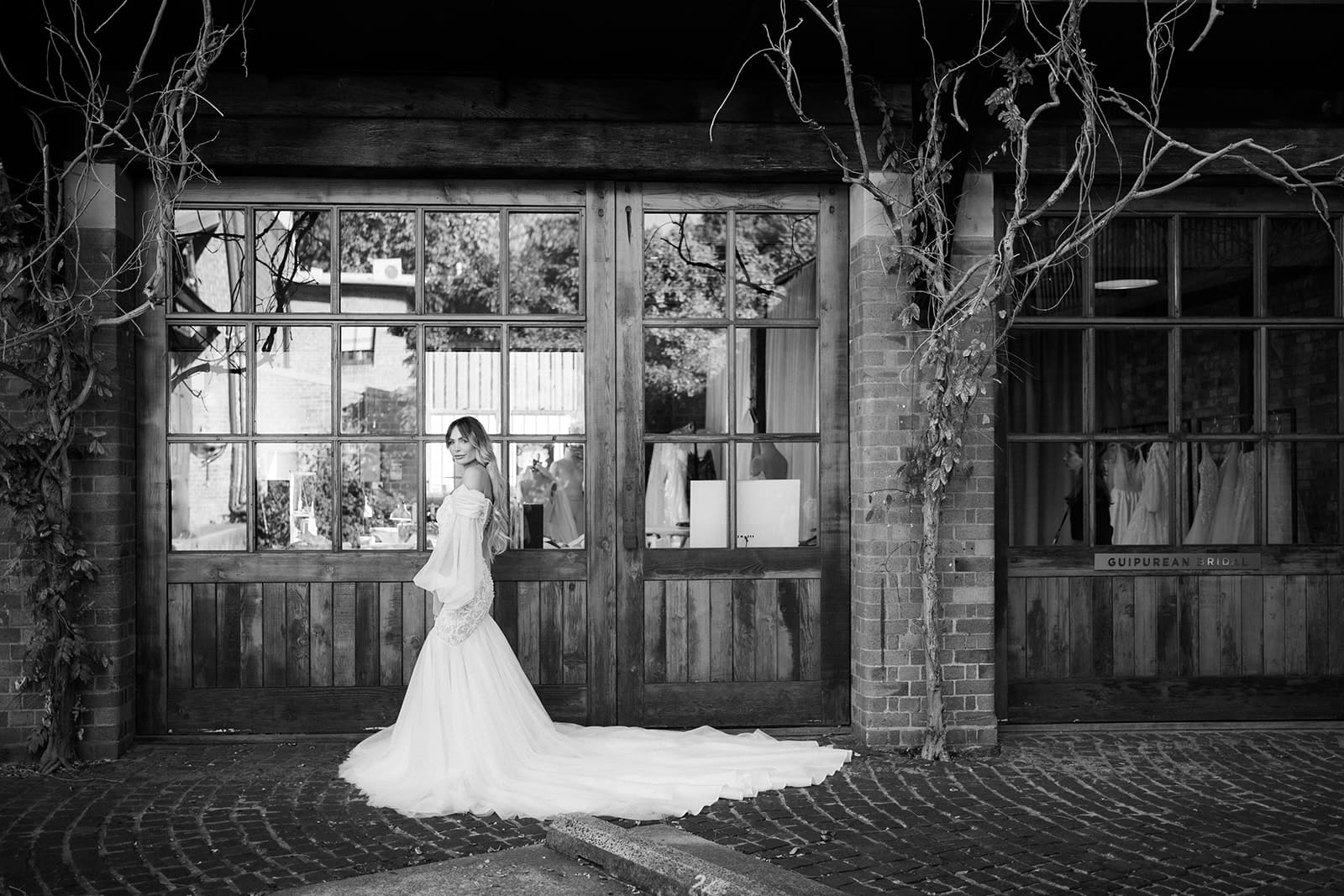 black and white photo girl pose with wedding gown