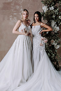 beautiful two girls posing with sleeve less white celene gowns