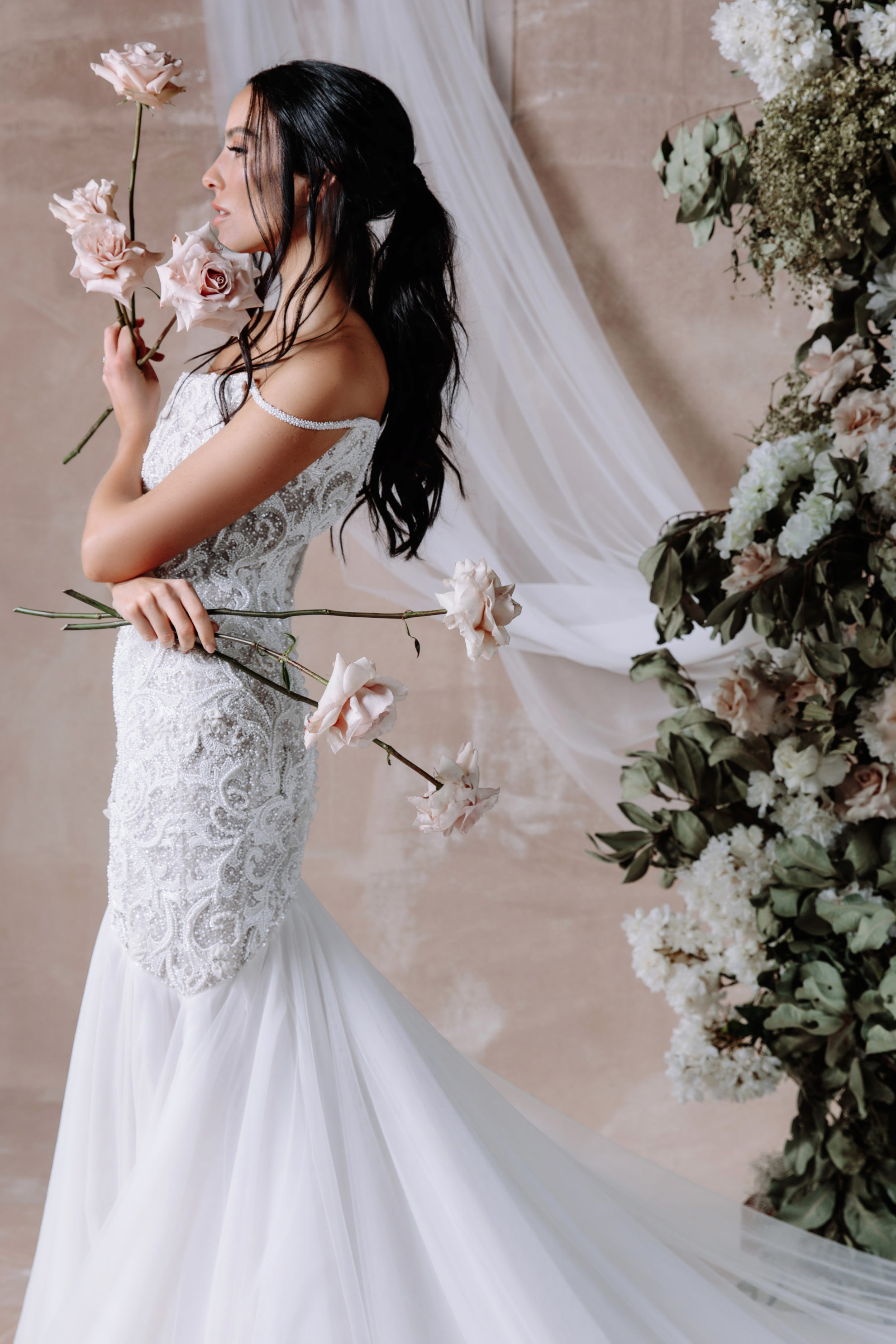 girl pose with celene gown and beautiful white rose