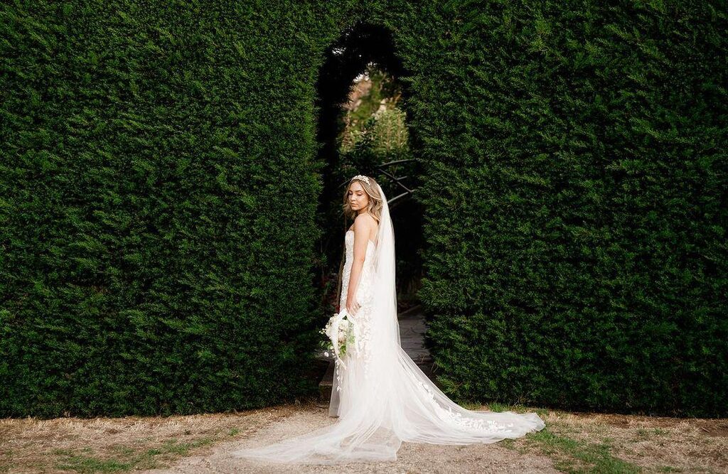 bride with white gown with greenery